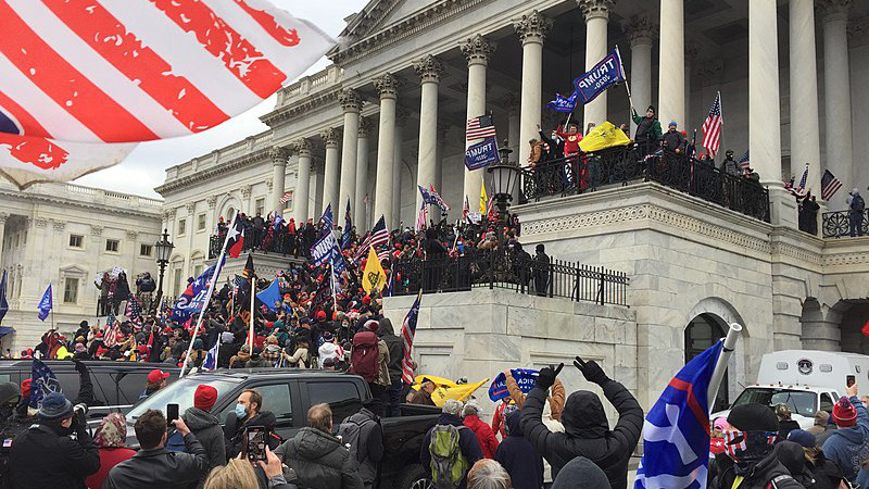 Trump supporters crowding the steps of the Capitol in Washington DC after displacing police shield wall preventing access. Photo Credit: TapTheForwardAssist, Wikipedia Commons