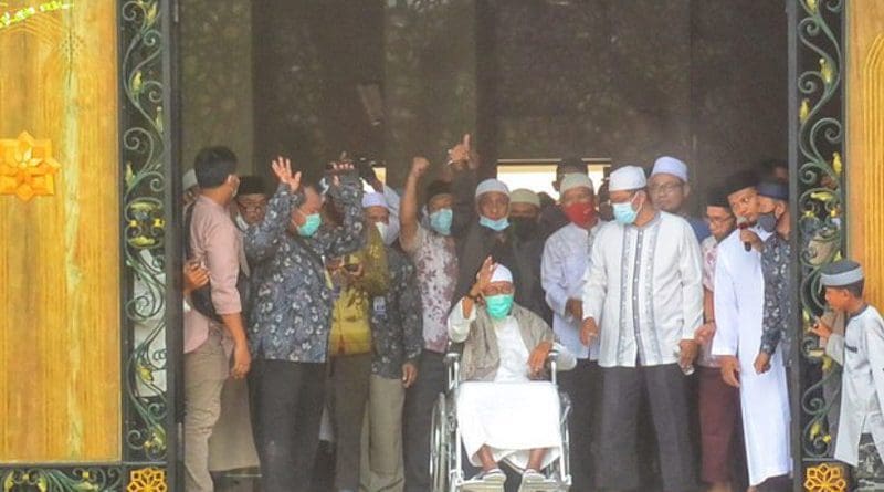Cleric Abu Bakar Bashir waves from a wheelchair upon arriving at the Al Mukmin Islamic Boarding School where he resides near Solo, Indonesia, after his release from prison on terror-related charges, Jan. 8, 2021. Kusumasari Ayuningtyas/BenarNews