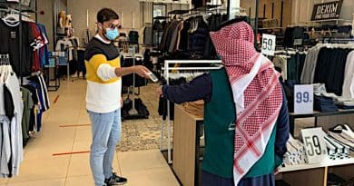 Retailer in Saudi Arabia checking health status via the Tawakkalna app of client. Photo Credit: SPA