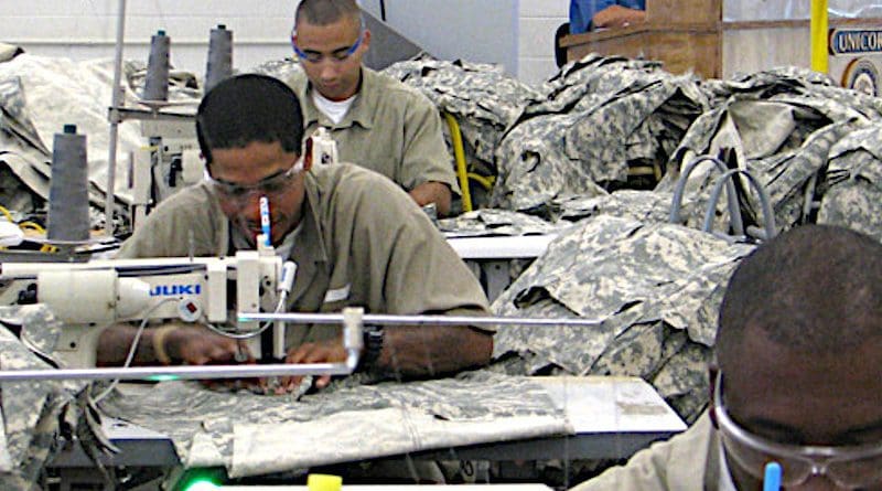 Prisoners work in a UNICOR (Federal Prison Industries) program producing uniforms. Photo Credit: Federal Bureau of Prisons