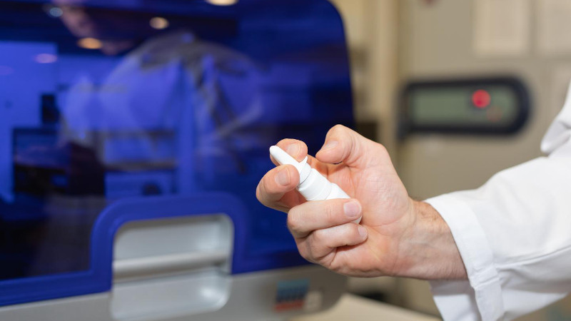 Associate Professor Nathan Bartlett holds a mockup of the immune boosting nasal spray in the HMRI labs in Newcastle, Australia. CREDIT Hunter Medical Research Institute