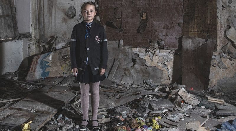 Masha Khromchenko stands in the kindergarten classroom that took a direct hit from a shell in the Luhansk region, Ukraine. Credit: UNICEF/Christopher Morris