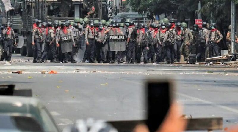 Military and police in Myanmar face off against protestors. Photo Credit: Mehr News Agency