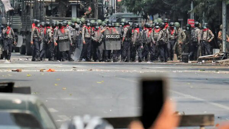 Military and police in Myanmar face off against protestors. Photo Credit: Mehr News Agency