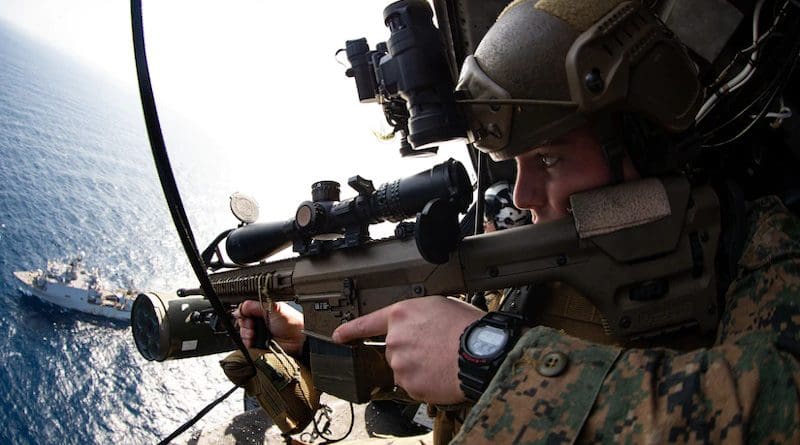 Reconnaissance Marine with Maritime Raid Force, 31st Marine Expeditionary Unit, provides aerial security using M110 semi-automatic sniper system during visit, board, search, and seizure mission after taking off from USS America, Philippine Sea, January 24, 2021 (U.S. Marine Corps/Brandon Salas)