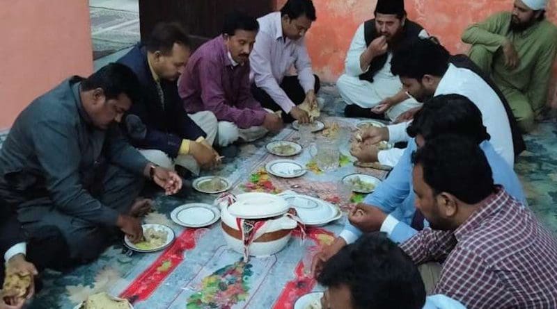 Mufti Sohail Shaukar Butt (right in black cap) enjoys an Iftar meal with a church group in Sahiwal, Punjab province, on March 25. (Photo: Ashiknaz Khokhar)