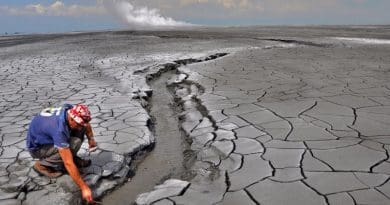 The Lusi eruption: A non accessible 650 m in diameter hot mud pond surrounds the central vents zone (rising plume is seen in the horizon). The erupted mud reaches temperatures of 100 °C and extensive oil slicks can be observed. Photo: Adriano Mazzini/CEED/UiO