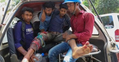 An injured man is loaded into a van after police fired on people protesting over wages and benefits at a Chinese-financed power plant in Banshkhali sub-district, southeastern Bangladesh, April 17, 2021. Photo Credit: BenarNews
