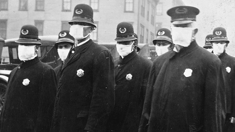 Policemen in Seattle wearing masks made by the Red Cross, during the influenza epidemic. December 1918. Photo Credit: Author unknown, Wikimedia Commons