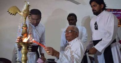 Bishop Rayappu Joseph lights an oil lamp during the launch in 2016 of ‘A Living Hero’, a book about his life. (Photo: UCA News reporter)
