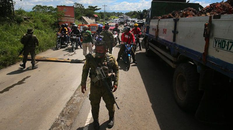 Troops secure the highway outside Datu Paglas town in Maguindanao, Philippines, during an attack by members of the Bangsamoro Islamic Freedom Fighters, a group aligned with the Islamic State, May 8, 2021. Mark Navales/BenarNews