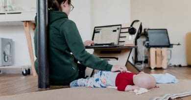 Mother working from home. Photo Credit: Standsome at Unsplash