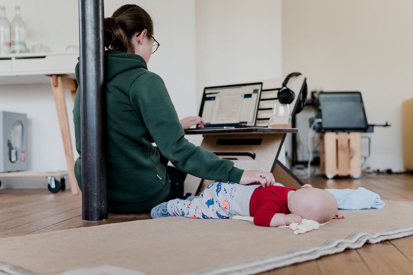 Mother working from home. Photo Credit: Standsome at Unsplash