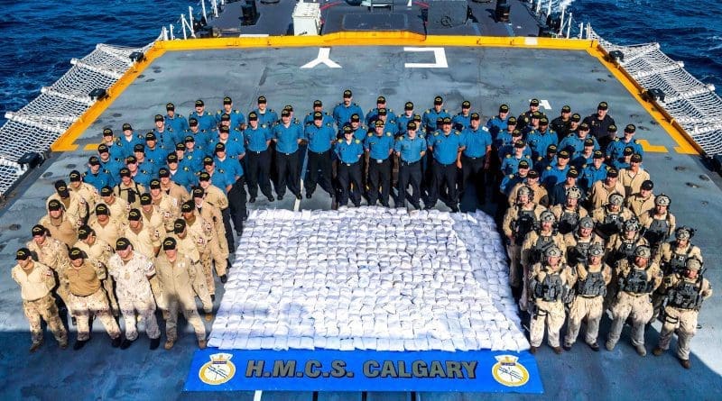 Members of HMCS CALGARY stand with 1286kg of heroin seized from a dhow during a counter-smuggling operation on 23 April, 2021 in the Arabian Sea during OPERATION ARTEMIS and as part of Combined Task Force 150. Please credit: Corporal Lynette Ai Dang, Her Majesty's Canadian Ship CALGARY, Imagery Technician ©2021 DND/MDN CANADA