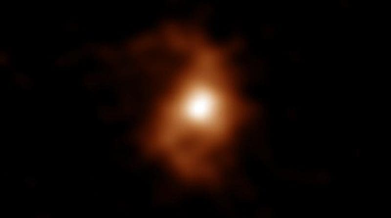 ALMA detected emissions from carbon ions in the galaxy. Spiral arms are visible on both sides of the compact, bright area in the center of the galaxy. CREDIT ALMA (ESO/NAOJ/NRAO), T. Tsukui & S. Iguchi
