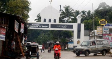 A motorcyclist passes an arch marking the limits of Marawi City in the southern Philippines. Photo Credit: Jeoffrey Maitem / BenarNews