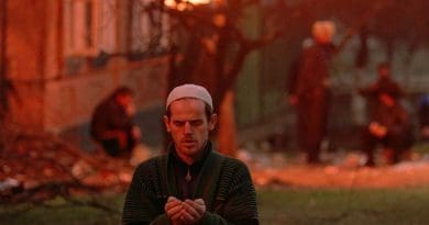 A Chechen man prays during the Battle of Grozny. Photo Credit: Mikhail Evstafiev, Wikipedia Commons