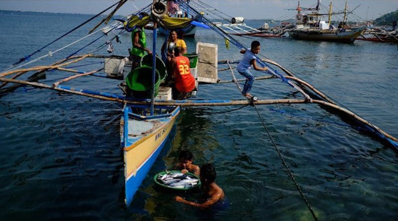Subsistence fishermen haul a catch from their boat to shore in Infanta, a town in the northern Philippine province of Pangasinan, which faces the South China Sea. [Photo Credit: Jason Gutierrez / BenarNews]