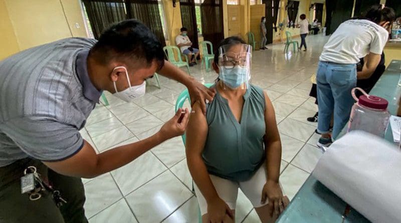 Woman gets coronavirus vaccine in Quezon City, Philippines. Photo Credit: Basilio Sepe/BenarNews