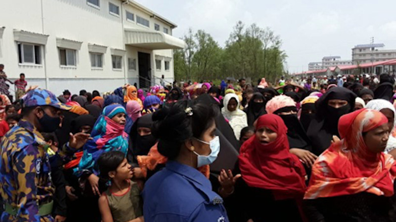 Rohingya refugees gather in an area of a complex housing at Bhashan Char in Bangladesh during a visit by senior officials of the United Nations refugee agency (UNHCR), May 31, 2021. (Source: BenarNews)