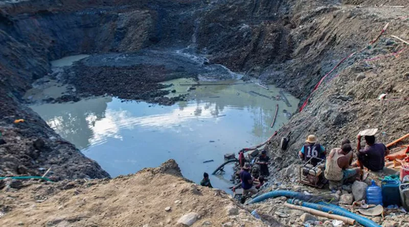People siphon water from a pit as they prospect for gold at a mining site in Central Sulawesi, Indonesia. Photo Credit: Keisyah Aprilia/BenarNews