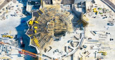 The eight pillars of the Shrine of ‘Abdu’l-Bahá are now complete, and scaffolding is being set up in the space between the pillars and the completed folding walls for work on the trellis that will span the central plaza. Photo Credit: BWNS