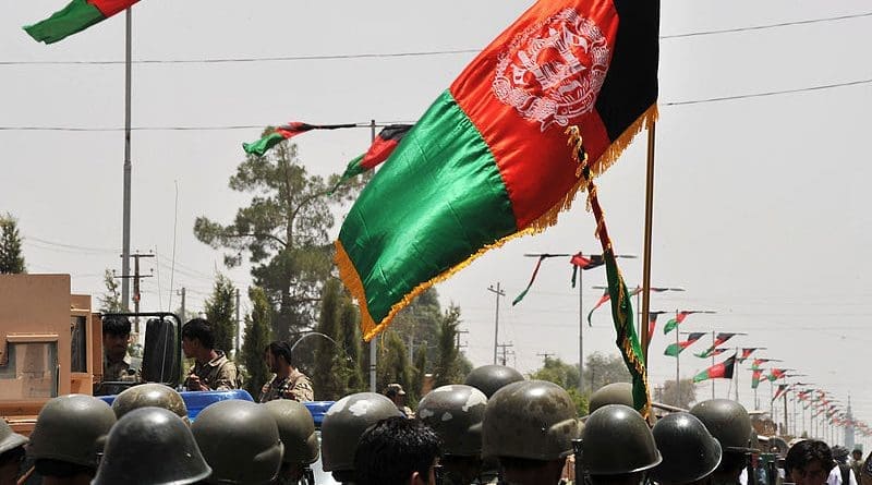 The flag of Afghanistan flies over the Afghan National Army. Photo Credit: POA Hamish Burke, Wikipedia Commons