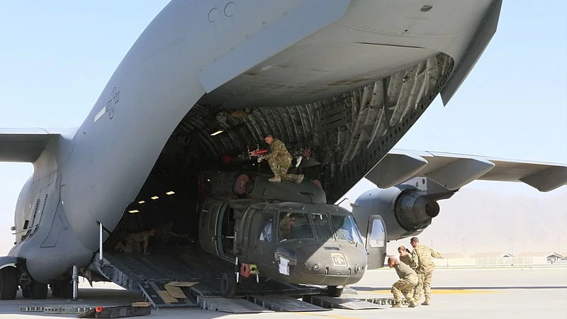 Aerial porters load a UH-60L Black Hawk helicopter unto a C-17 Globemaster III for departure from Bagram Airfield, 16 June 2021. Photo Credit: Sgt. 1st Class Corey Vandiver