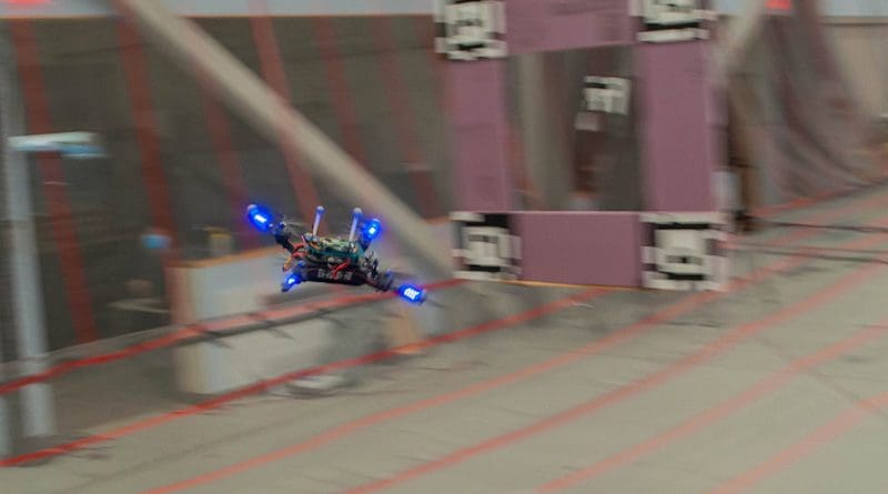 A quadcopter flies a racing course through several gates in order to find the fastest feasible trajectory. CREDIT: Courtesy of Sertac Karaman, Ezra Tal, et al