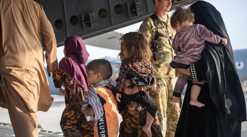 Air Force loadmasters and pilots assigned to the 816th Expeditionary Airlift Squadron help passengers board a U.S. Air Force C-17 Globemaster III in support of the Afghanistan evacuation at Hamid Karzai International Airport in Kabul, Afghanistan, Aug. 24, 2021. Photo Credit: DOD