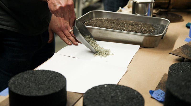 Lab staff in the Mizzou Asphalt Pavement and Innovation Lab, or MAPIL, show the plastic waste particles that are being added to the pavement mixture. The lab is located inside the MU College of Engineering. CREDIT: University of Missouri