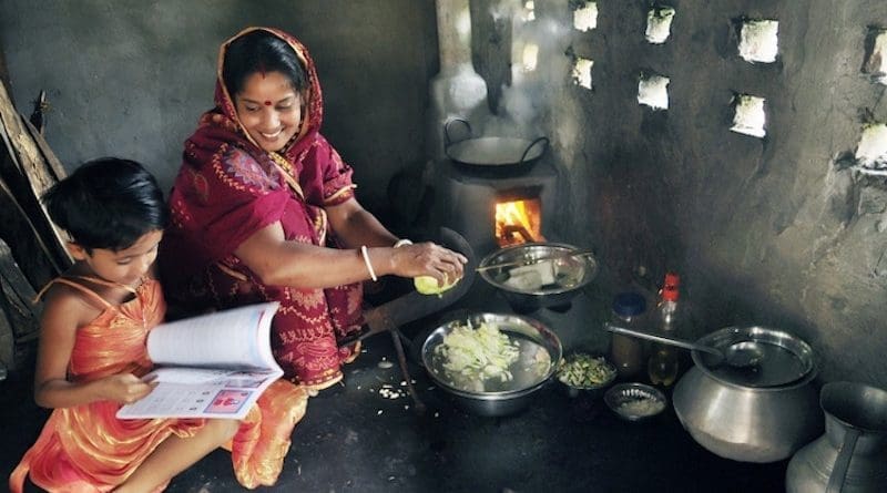 Ms. Shefali Ghosh from Savar, near Dhaka, teaches her daugher in the kitchen. Credit: The World Bank