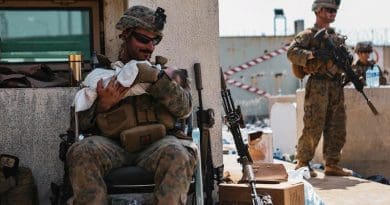 A Marine calms an infant at Hamid Karzai International Airport, Kabul, Afghanistan, Aug. 20. Service members and coalition partners are assisting the Department of State with a non-combatant evacuation operation in Afghanistan. Photo Credit: Marine Corps Sgt. Isaiah Campbell