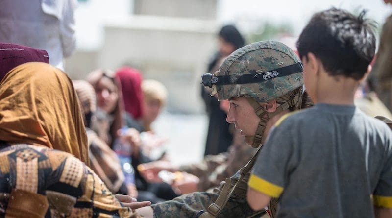 A Marine checks the well-being of evacuees at Hamid Karzai International Airport, Kabul, Afghanistan, Aug. 20, 2021. U.S. service members are assisting the Department of State with an orderly drawdown of designated personnel in Afghanistan. Photo Credit: Marine Corps Sgt. Samuel Ruiz