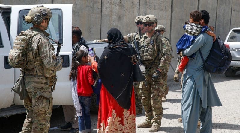 US Army Soldiers assigned to 3rd Brigade, escort a young family to the terminal for check-in at Hamid Karzai International Airport in Kabul, Afghanistan. Photo Credit: DOD