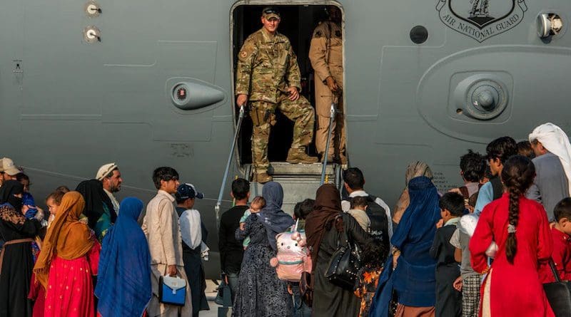 Service members prepare to board evacuees onto a C-17 Globemaster lll at Al Udeid Air Base, Qatar, Aug. 22, 2021. Photo Credit: Air Force Airman 1st Class Kylie Barrow