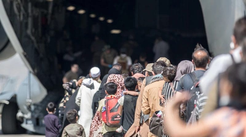 Families board a U.S. Air Force C-17 Globemaster III during an evacuation at Hamid Karzai International Airport, Kabul, Afghanistan, Aug. 24, 2021. Photo Credit: Marine Corps Sgt. Samuel Ruiz