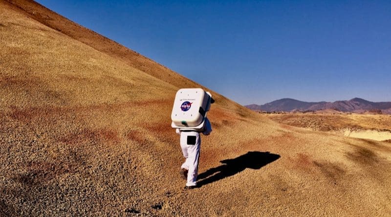 NASA Haughton-Mars Project field test of new technologies for human Moon and Mars science and exploration in Oregon. Shown here is the Collins Aerospace spacesuit for analog studies, equipped with integrated Information Technologies and Informatics Subsystem (IT IS), undergoing testing in the Moon and Mars-like landscape of the Painted Hills at John Day Fossil Beds National Monument. CREDIT (NASA Haughton-Mars Project / Sawan Dalal)