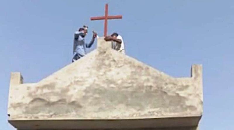 Laborers remove a cross from the Church of the Nazarene after objections from an angry Muslim mob in Pakistan's Punjab province. (Photo supplied by Pastor Rafaqat Yaqoob)