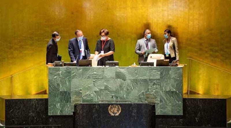 Masked staffers at the podium of the UN General Assembly in 2020. Photo Credit: United Nations