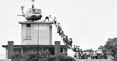 A member of the CIA helps evacuees up a ladder onto an Air America helicopter on the roof of 22 Gia Long Street April 29, 1975, shortly before Saigon fell to advancing North Vietnamese troops. Photo Credit: Hubert van Es, Wikipedia Commons