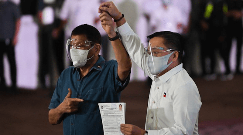 Philippine President Rodrigo Duterte (left) accompanies Sen. Christopher “Bong” Go as the lawmaker files his certificate of candidacy to enter the vice-presidential race, in Manila, Oct. 2, 2021. Photo Credit: FOCAP Pool/BenarNews