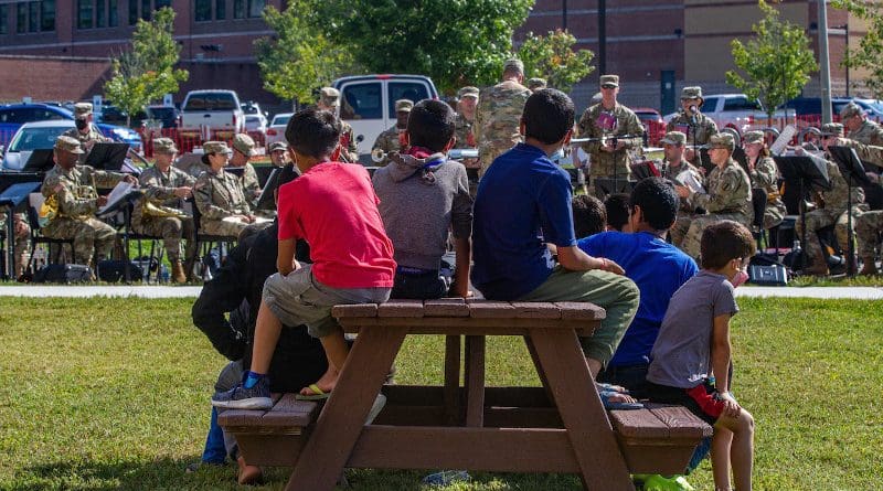 Afghan personnel watch a live performance from the U.S. Army Training and Doctrine Command band in the living support area as part of Operation Allies Welcome at Fort Lee, Va., Sept. 29, 2021. Photo Credit: Army Sgt. Andre Taylor