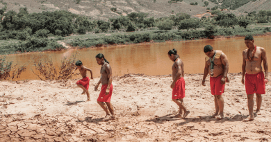 Krenak youths on the shore of the Doce River in the aftermath of Brazil’s worst environmental disaster: the collapse of a tailings dam in the municipality of Mariana, in Minas Gerais state, in 2015. The toxic sludge left the river unusable, affecting the culture, safety, and food and water supply for the Krenak Indigenous people and thousands of others. Image courtesy of Nicoló Lanfranchi/Greenpeace.