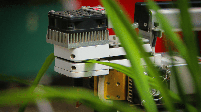 Photo of infra-red gas analyzer and a rice leaf. The leaf is placed inside a cuvette in which conditions related to light intensity, CO2 concentration, relative humidity, and temperature can be controlled. CREDIT: International Rice Research Institute