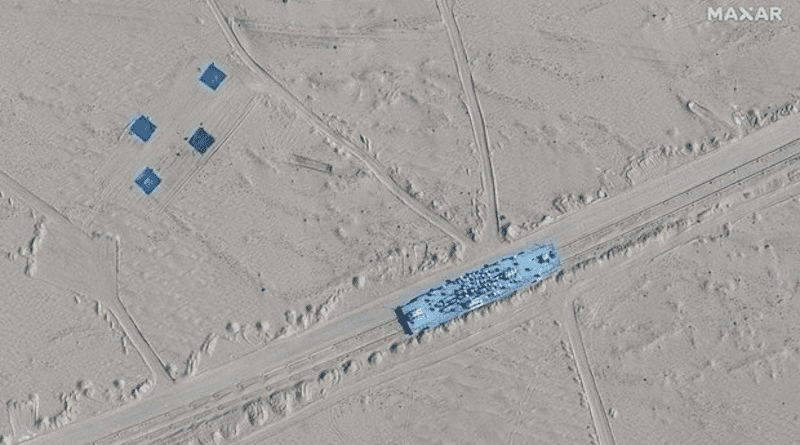 Satellite image provided by Maxar Technologies shows a structure shaped like an aircraft carrier on rail tracks in Ruoqiang county, China, Oct. 20, 2021. Photo Credit: Maxar Technologies