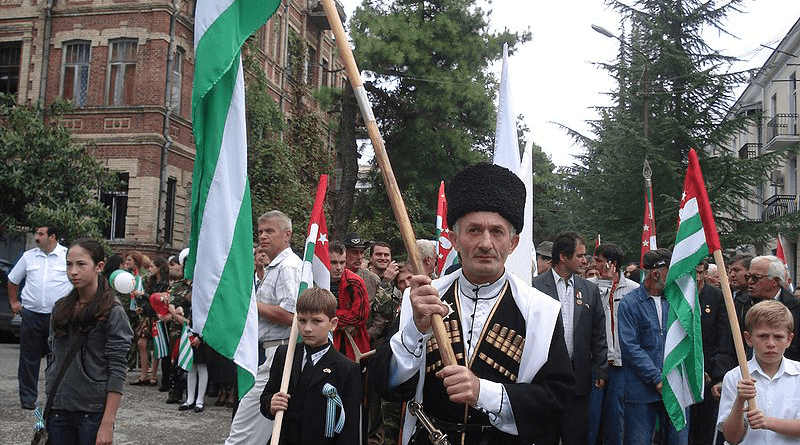 Abkhazians carrying the republic's flags in a parade. Photo Credit: Apsuwara, Wikipedia Commons
