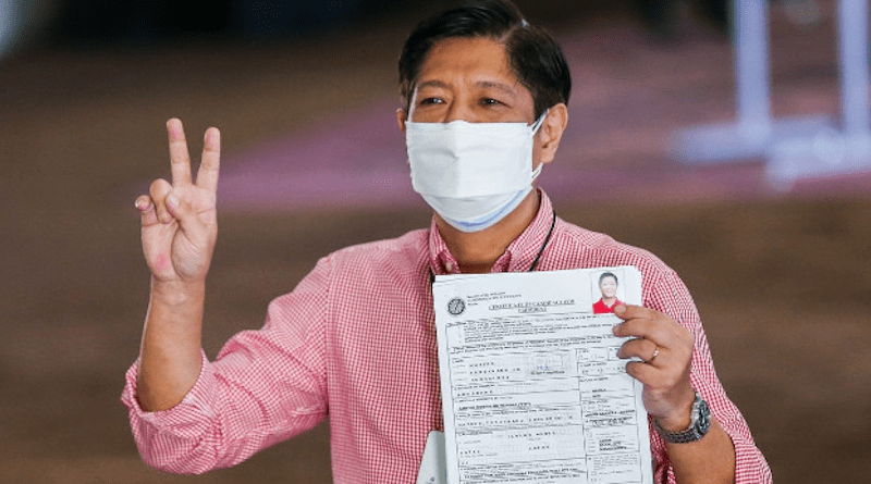 Candidate Ferdinand Marcos Jr., the son and namesake of the late Philippine dictator, flashes a victory sign as he shows his certificate of candidacy after filing to join the May 2022 presidential race, in Manila, Oct. 6, 2021. [Rouelle Umali/BenarNews]
