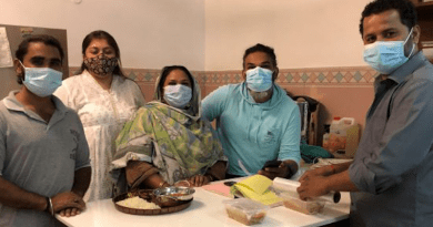 Alia Chughtai (standing at the back), a journalist with filmmaker Akhlaque Mahesar (right, behind the table), and others in their team at Aur Chaawal (And Rice). Chughtai believes in using local fresh ingredients that are healthy and planet-friendly. Her method of cooking fits in with the Barilla Center for Food and Nutrition’s Double Pyramid. Credit: Zofeen T. Ebrahim/IPS
