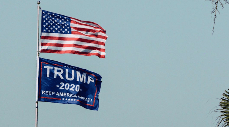The flag of the United States of America above a flag of Donald Trump’s 2020 presidential bid. CREDIT: Dalton Caraway, Unsplash, CC0 (https://creativecommons.org/publicdomain/zero/1.0/)
